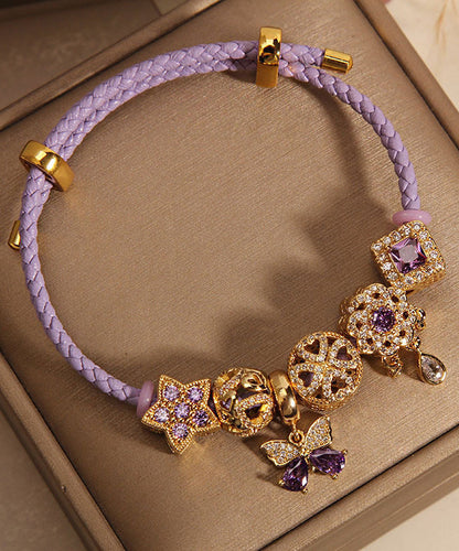 Pulsera elegante de plata de ley morada con circonitas doradas, mariposa, estrella y gota de agua