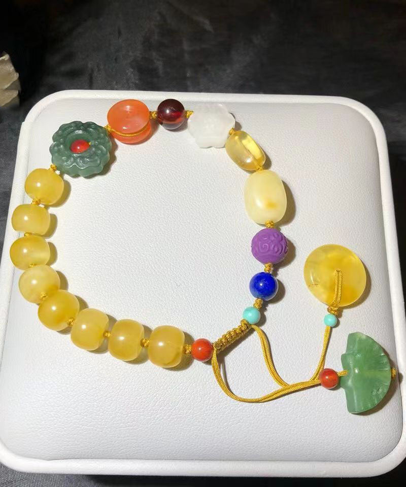 Pulsera con dijes de cera de abeja tejida a mano con arcoíris