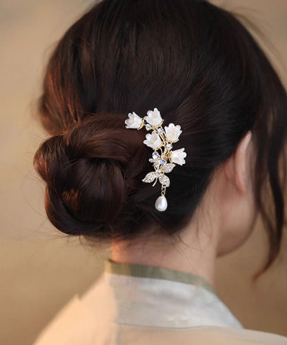 Horquilla elegante en forma de U con diseño de lirio de los valles y circonitas blancas