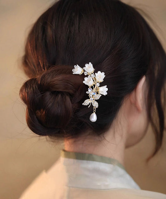 Horquilla elegante en forma de U con diseño de lirio de los valles y circonitas blancas