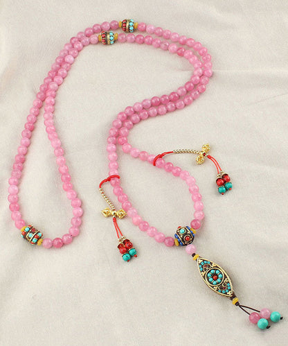 Edle Halskette mit Anhänger aus gelber Kupferlegierung mit Achatperlen und Quaste