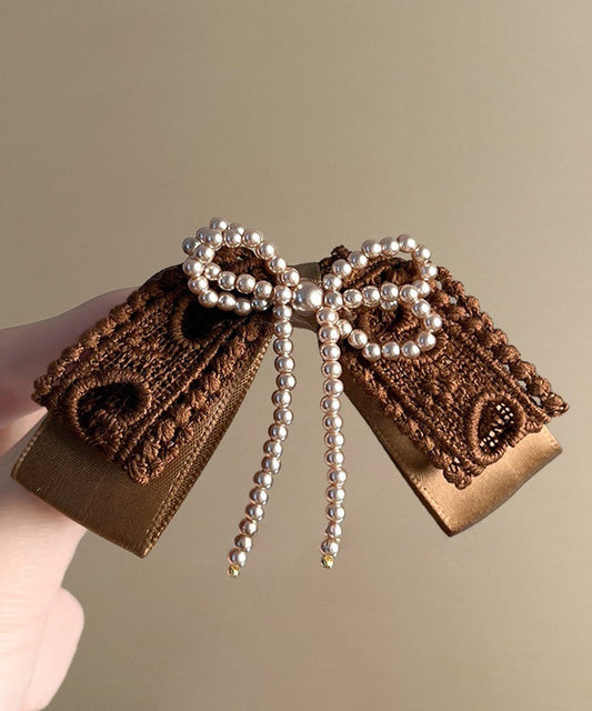 Horquilla con lazo de perlas para manualidades textiles con café