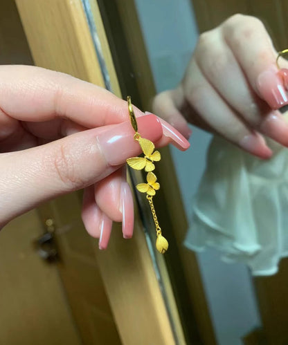 Elegante Ohrringe mit Schleife und Quaste in Goldlegierung