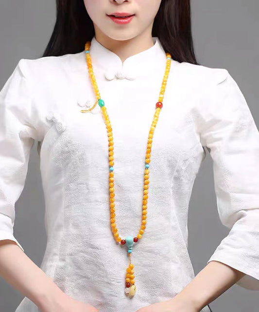 Elegante collar con colgante de borla con cuentas de cera de abeja, ámbar y jade amarillo