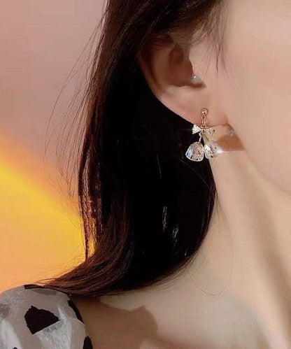 Pendientes colgantes con forma de campana y lazo de circonitas doradas y cobre