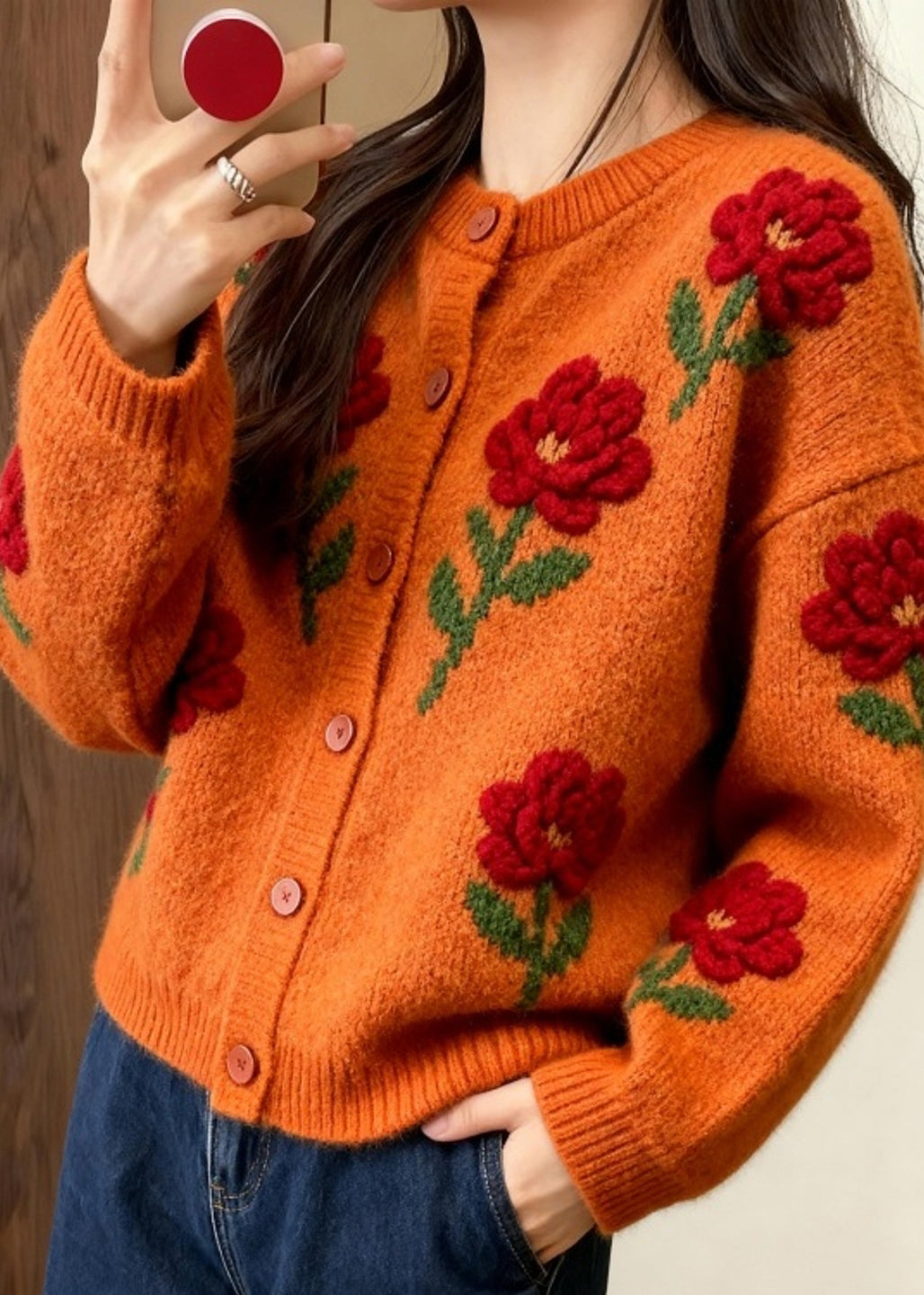 Cárdigan holgado de punto con estampado floral y cuello redondo de color naranja a la moda para primavera.