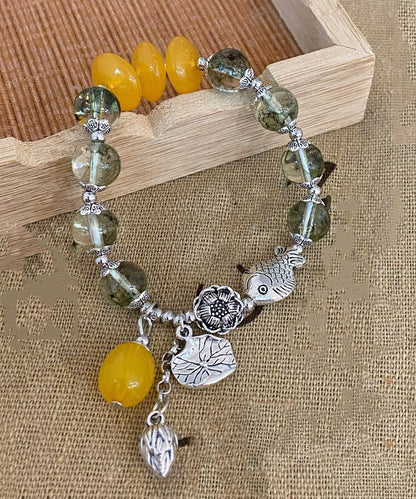 Modisches Bettelarmband aus Sterlingsilber mit Kristallen und kleinen Fischen, die mit einer Lotusblüte spielen