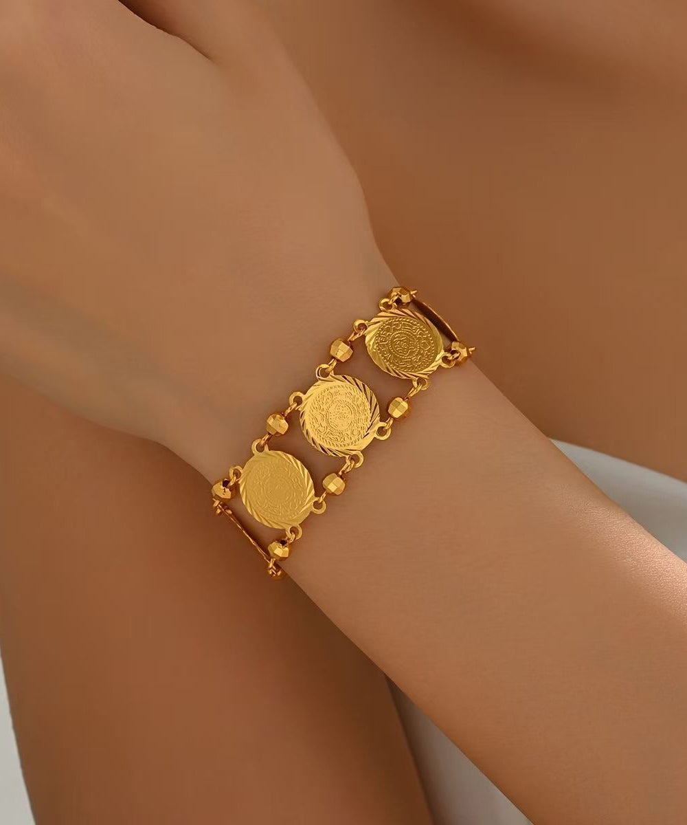 Doppellagiges Armband mit Münzanhänger aus feinem Gold und Sterlingsilber mit Übergoldung.