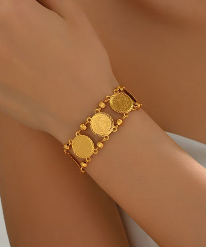 Doppellagiges Armband mit Münzanhänger aus feinem Gold und Sterlingsilber mit Übergoldung.