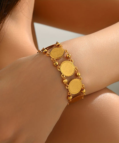 Doppellagiges Armband mit Münzanhänger aus feinem Gold und Sterlingsilber mit Übergoldung.