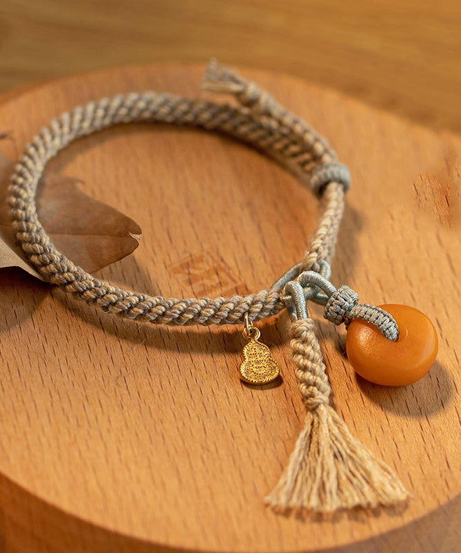 Feines Khaki-Handstrickarmband mit Bienenwachs-Kürbisquaste