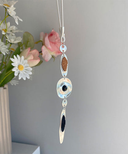 Halskette mit Anhänger in Tropfenform aus feiner Seide, Edelstahl und Leder