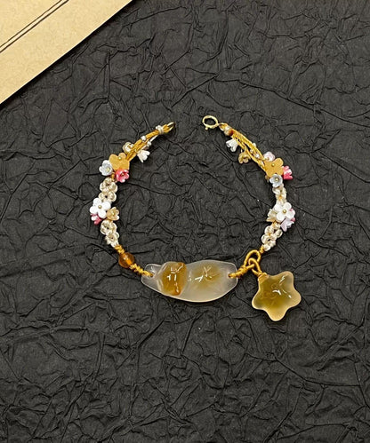 Pulsera con dijes de estrellas y gatos de Osmanthus azul tejida a mano
