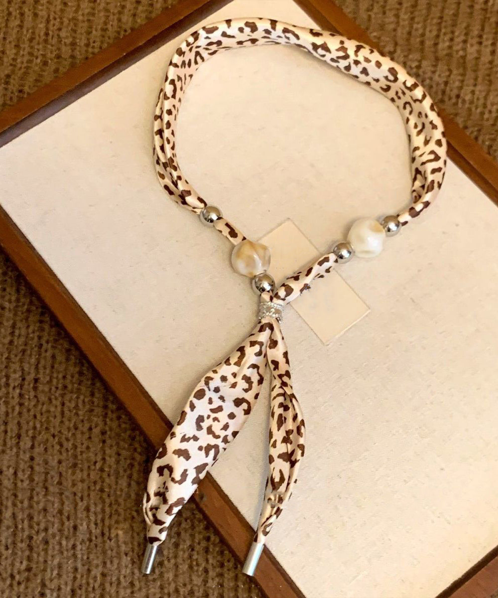 Collar con colgante de bufanda tejida con cuentas y estampado caqui hecho a mano