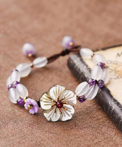 Handgefertigtes Charm-Armband mit Blumenmotiv und violettem Kristall