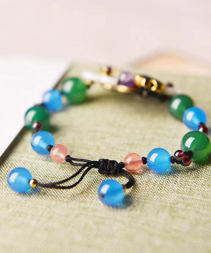 Handgefertigtes Charm-Armband mit Blumenmotiv und violettem Kristall