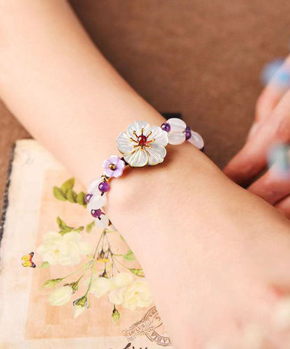 Handgefertigtes Charm-Armband mit Blumenmotiv und violettem Kristall