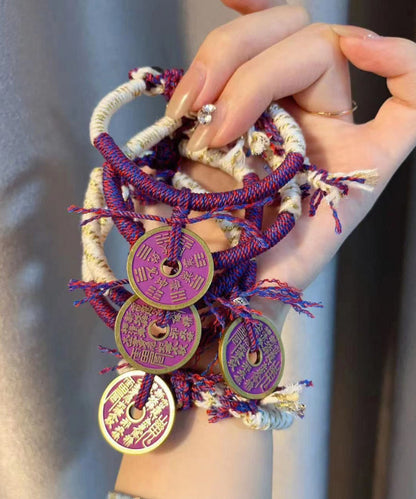 Pulsera tejida a mano con borlas moradas