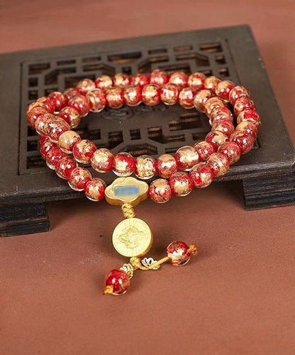 Pulsera con dijes de Buda esmaltados en rojo, hecha a mano