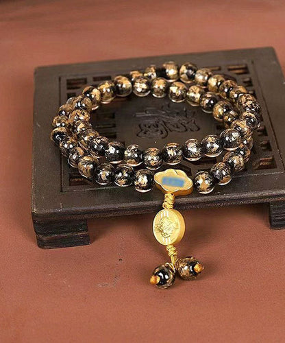 Pulsera con dijes de Buda esmaltados en rojo, hecha a mano