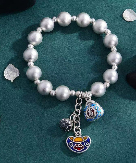 Pulsera suelta de seda con dijes cloisonné y cobre plateado