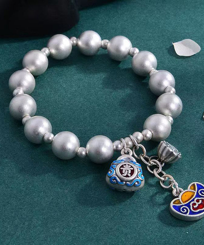 Pulsera suelta de seda con dijes cloisonné y cobre plateado