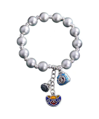 Pulsera suelta de seda con dijes cloisonné y cobre plateado