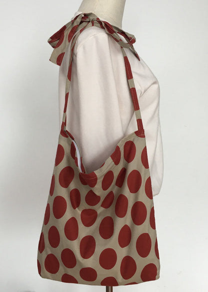 Moderne Messenger Bag aus Canvas mit orangefarbenem Punktmuster