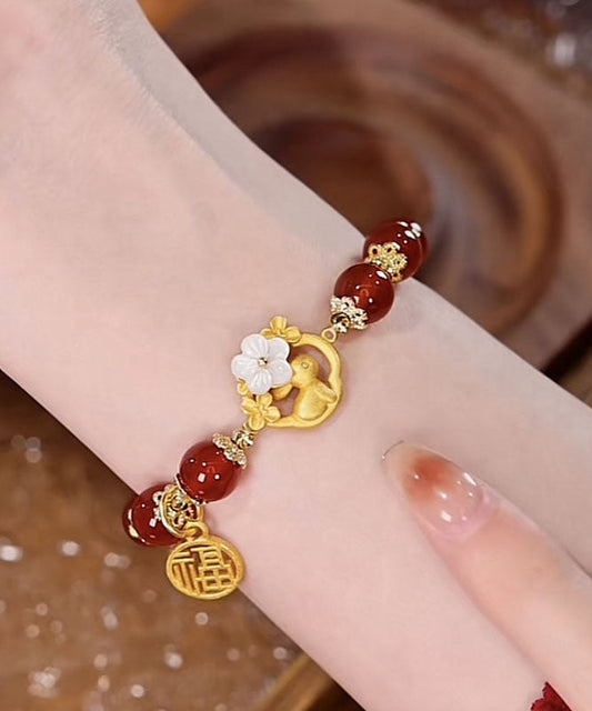 Pulsera moderna de plata de ley roja con incrustaciones de ágata y jade floral.