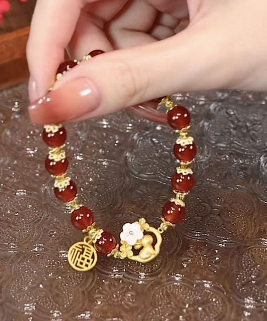 Pulsera moderna de plata de ley roja con incrustaciones de ágata y jade floral.