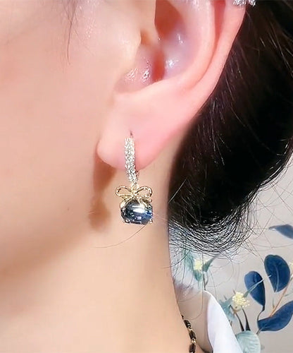 Nuevos pendientes de aro con lazo de cristal y circonitas doradas y cobre