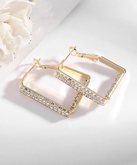 Übergroße Creolen aus goldenem Sterlingsilber mit Kupfereinlage und geometrischen Zirkonblöcken