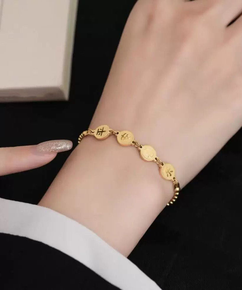 Normales Charm-Armband aus vergoldetem Edelstahl mit grafischer Quaste