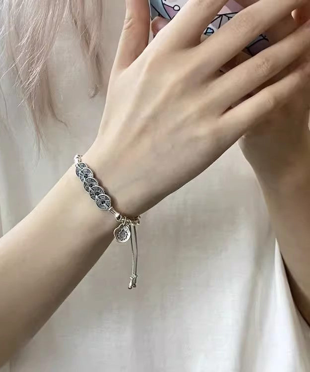 Pulsera de seda retro con borlas y cinco monedas del emperador en plata de ley