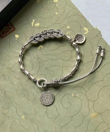 Pulsera de seda retro con borlas y cinco monedas del emperador en plata de ley