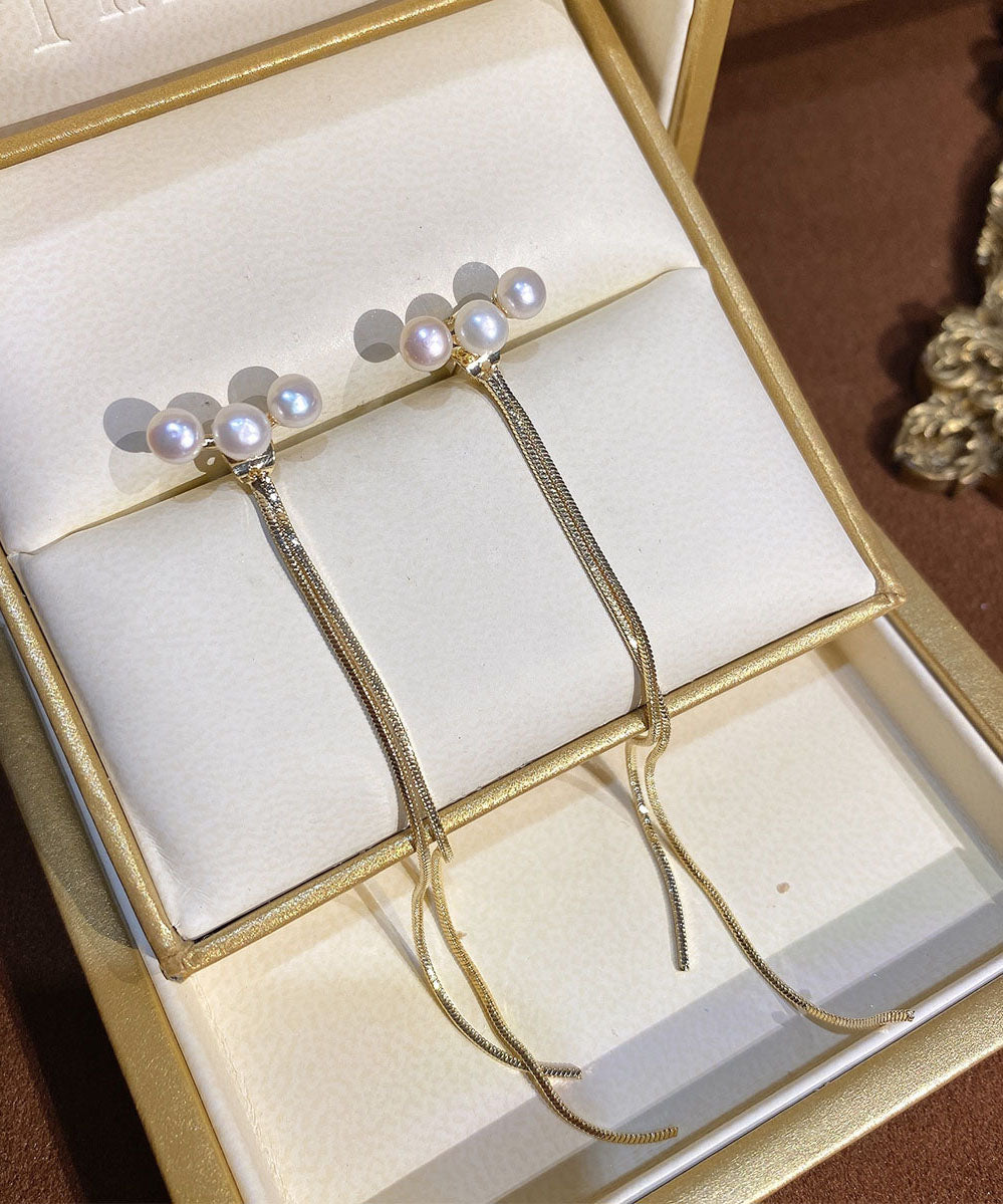 Schmale, vergoldete Ohrringe mit Perlenquaste in Kupferoptik