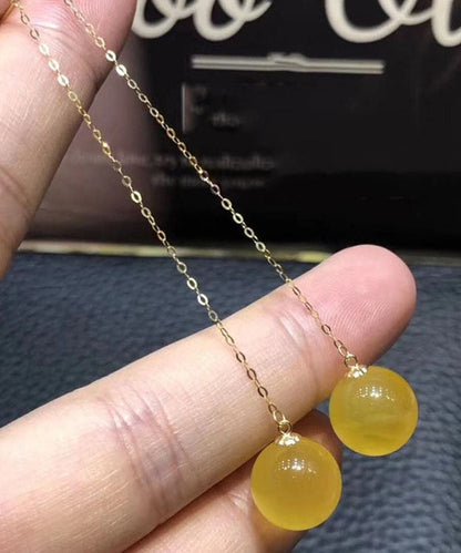 Schmale Gelbgold-Ohrhänger aus 18 Karat Bernstein und Honigwachs