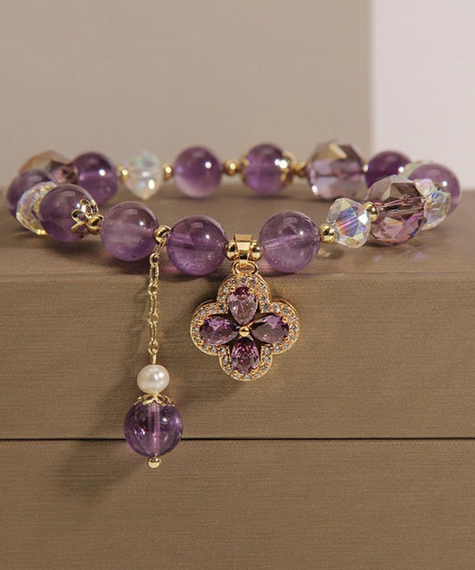 Pulsera con borla y trébol de cuatro hojas con incrustaciones de cristal morado