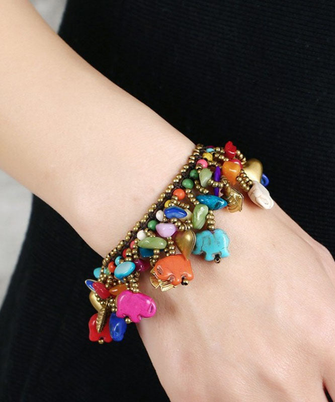Pulsera con dijes de cera turquesa tejida a mano de cobre arcoíris