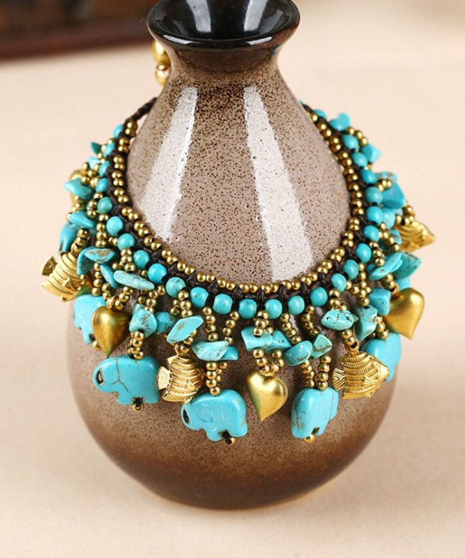 Pulsera con dijes de cera turquesa tejida a mano de cobre arcoíris