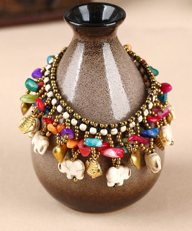 Pulsera con dijes de cera turquesa tejida a mano de cobre arcoíris