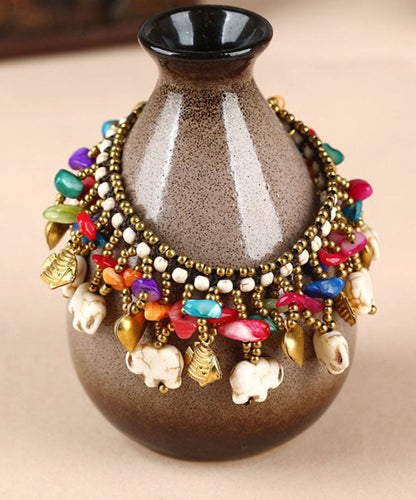 Pulsera con dijes de cera turquesa tejida a mano de cobre arcoíris