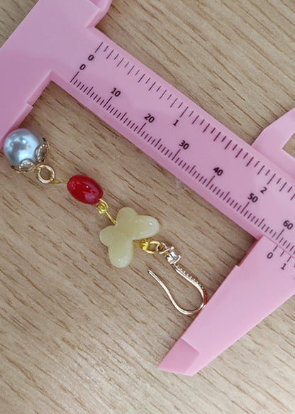 Elegantes pendientes colgantes de mariposa, cera de abejas, perla y circonita