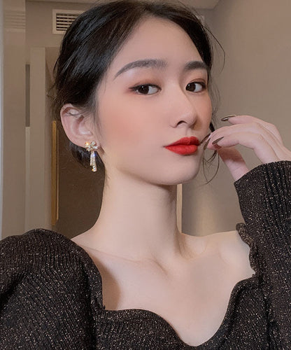 Elegantes pendientes colgantes con borlas y lazo de circonita de aleación de oro