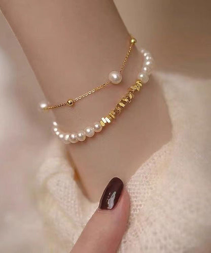 Stilvolles zweiteiliges Charm-Armband-Set aus vergoldeten Kupferperlen mit zerkleinerter Silberquaste