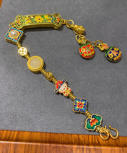 Pulsera vintage con colgante de borlas y múltiples elementos de esmalte azul quemado