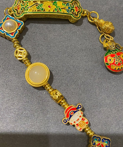 Pulsera vintage con colgante de borlas y múltiples elementos de esmalte azul quemado