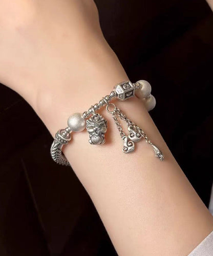 Pulsera vintage de seda con borlas de ágata y plata de ley