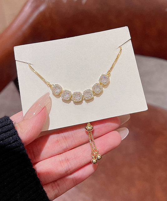 Pulsera Vogue con borlas de circonitas doradas y cobre